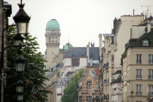 Preview: Cityscape featuring a street with several buildings in the background in Paris, France