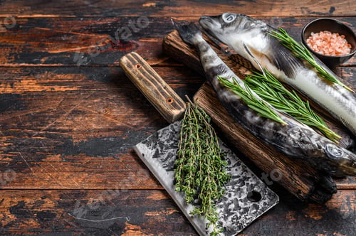Preview: Whole fresh Raw icefish on a wooden cutting board. Wooden background. Top view. Copy space