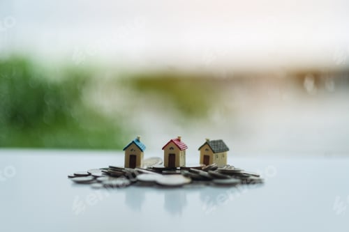 Preview: House models on pile of coins for saving money concept
