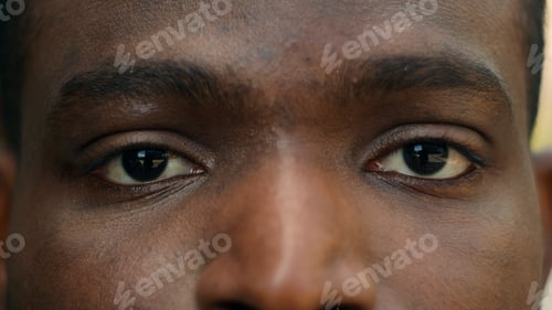 Preview: Close up cropped view detail ad male African American ethnic dark eyes close open blink