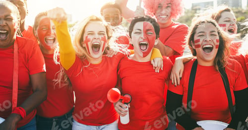 Preview: Multiracial red sport fans screaming while supporting their team - Football supporters having fun at