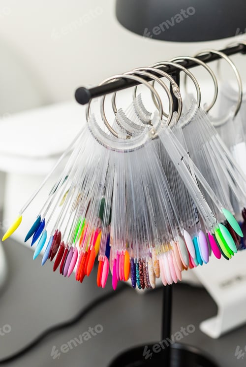 Preview: Collection of nails color polish samples. A palette of nail designs of different colors with gel