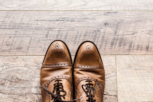 Preview: top view of pair of leather brown shoes on wooden floor