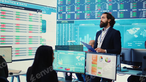 Preview: Chief executive officer reviews data shown on big display in the office