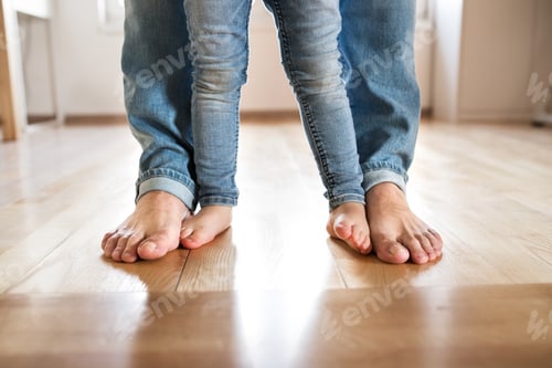 Preview: Beautiful young family. Bare feet of father and daughter.
