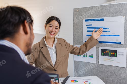 Preview: Business colleagues are actively engaged in a collaborative meeting, reviewing charts
