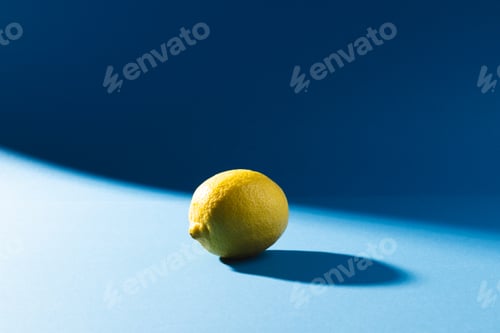 Preview: Close up of lemon and copy space on blue background