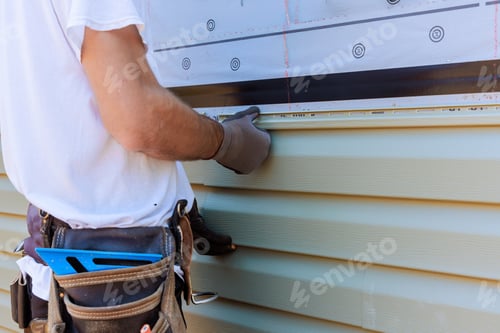 Preview: Handyman process installing vinyl PVC siding during construction on a facade new home