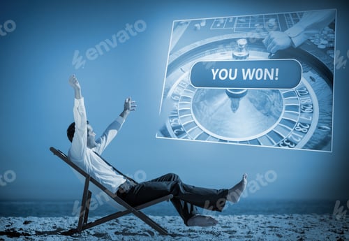 Preview: Businessman Sitting On Deck Chair Looking At Holographic Screen In Blue Light On The Beach