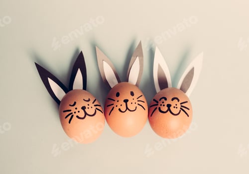 Preview: Three smiling bunnies laying on the floor.