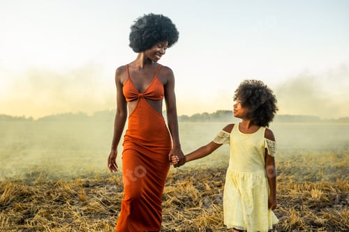 Preview: Beautiful mom and daughter in a sunflowers field