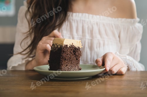 Preview: A woman eats a piece of chocolate cake, close-up.