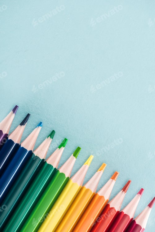 Preview: top view of rainbow multicolored pencils on blue background, lgbt concept