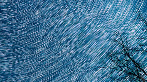 Preview: Bright Blue Cosmic Conception. Hyperlapse Spin Trails Of Stars Above Tree Crowns Without Foliage