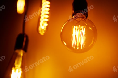 Preview: Set of a vintage light bulb on orange background