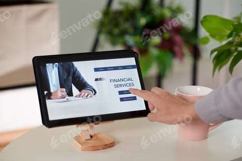Preview: Hand of young businesswoman pointing at homepage on tablet screen