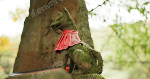 Preview: Fox statue at shrine in forest with spiritual history, Japanese culture and vintage art in nature.