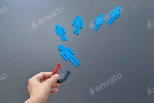 Preview: A hand holding a magnet attracts blue wooden figures.