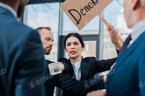 Preview: selective focus of businessman standing near attractive journalist with microphone reaching