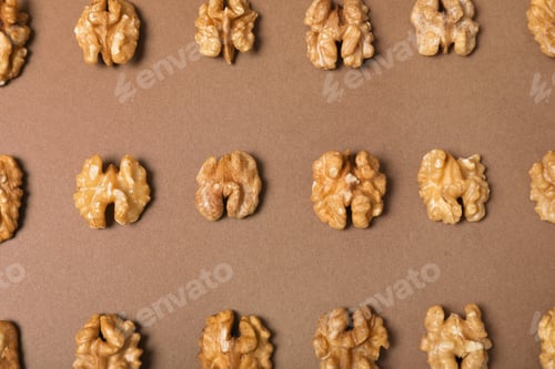 Preview: Tasty walnuts on color background, flat lay