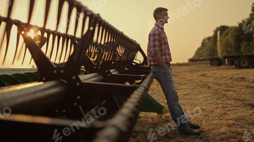 Preview: Farmer relax golden field at combine harvester alone. Agribusiness concept