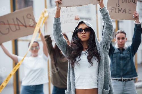 Preview: In sunglasses and hood. Group of feminist women have protest for their rights outdoors
