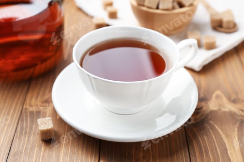 Preview: Aromatic black tea and sugar cubes on wooden table, closeup