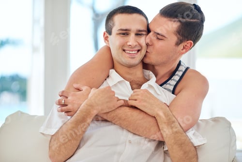 Preview: Life together is always special. Shot of a gay couple relaxing together at home.
