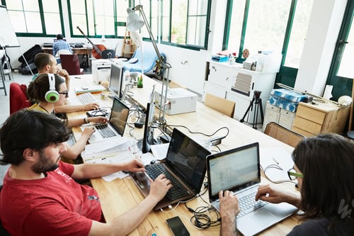 Preview: Collaborative teamwork in a bustling modern office space.