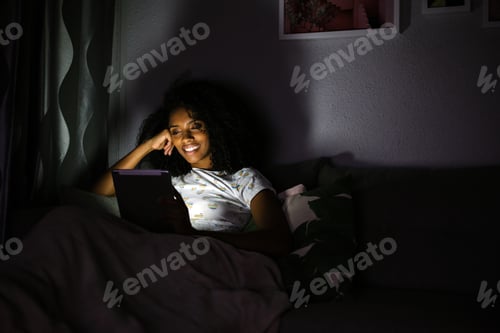 Preview: Woman in pajamas with a tablet