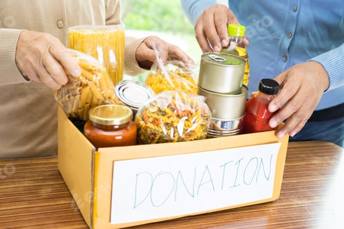Preview: Volunteers putting various dry food in donation box for help people.