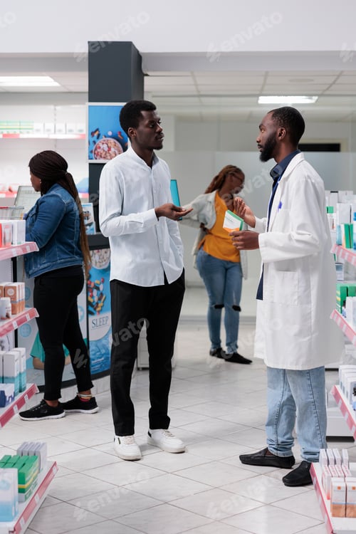 Preview: African american customers purchasing medicaments in pharmacy store