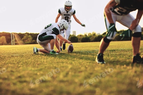 Preview: American football players practicing place kicking during a team practice