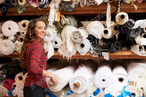 Preview: Young white woman selecting fabrics looking to camera