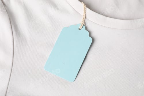 Preview: Cardboard tag on white t-shirt, top view