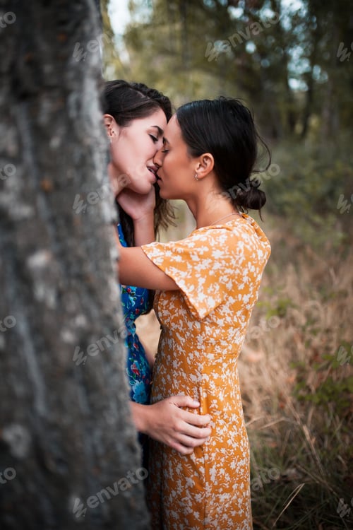 Preview: Two women kissing in the woods with dresses