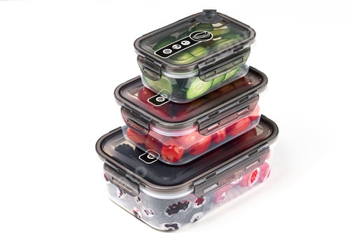 Preview: Closeup of plastic containers filled with tomatoes, cucumbers, blackberries, and strawberries
