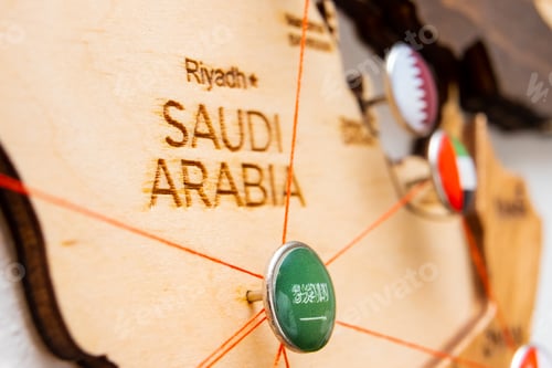 Preview: Saudi Arabia flag on the pushpin and red threads on the wooden map