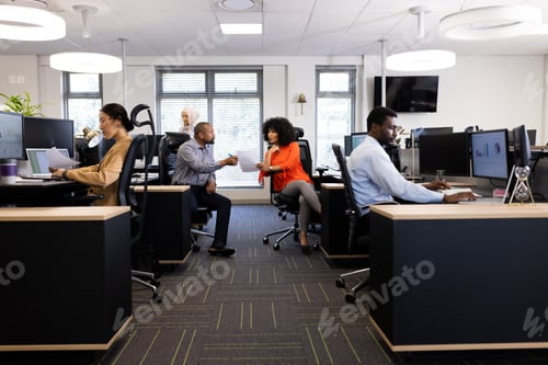 Preview: Diverse female and male businesspeople working in office with open space