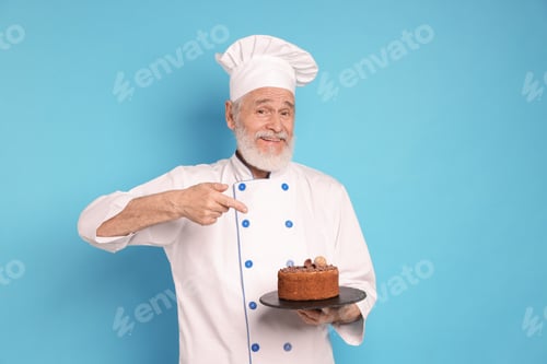Preview: Professional pastry chef with delicious chocolate cake on light blue background