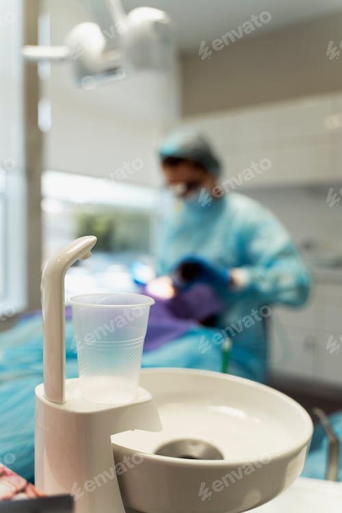 Preview: Dental sink, glass of water in modern dental office, clinic, selective focus, closeup
