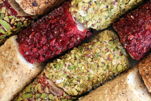 Preview: Rolls of turkish delight with many different flavors and fillings close up on table