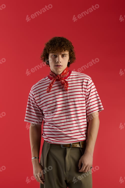 Preview: Teenager showcasing unique style in red and white striped attire against vibrant backdrop