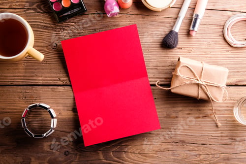 Preview: Red empty greeting card on table. Make up products.