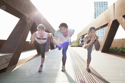 Preview: Man and two women training on one leg on urban footbridge