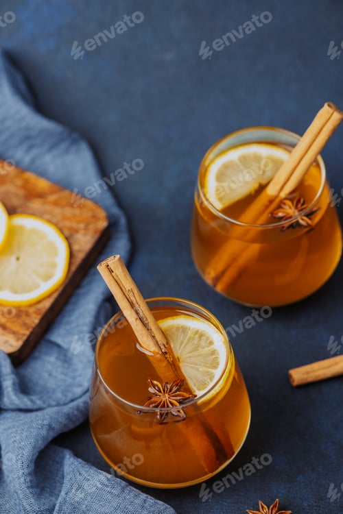Preview: Warm spiced drinks with cinnamon, lemon, and star anise in glasses