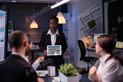 Preview: Focused workaholic entrepreneur woman with dark skin explaining management strategy