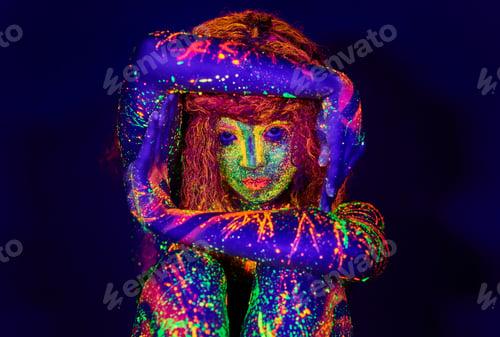 Preview: Let your light shine. Cropped portrait of a young woman posing with neon paint on her face.
