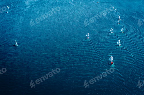 Preview: Regatta of small boats on blue lake in sunny day