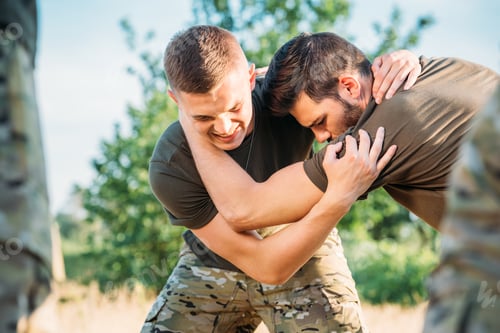 Preview: selective focus of young soldiers practicing hand to hand fighting on range